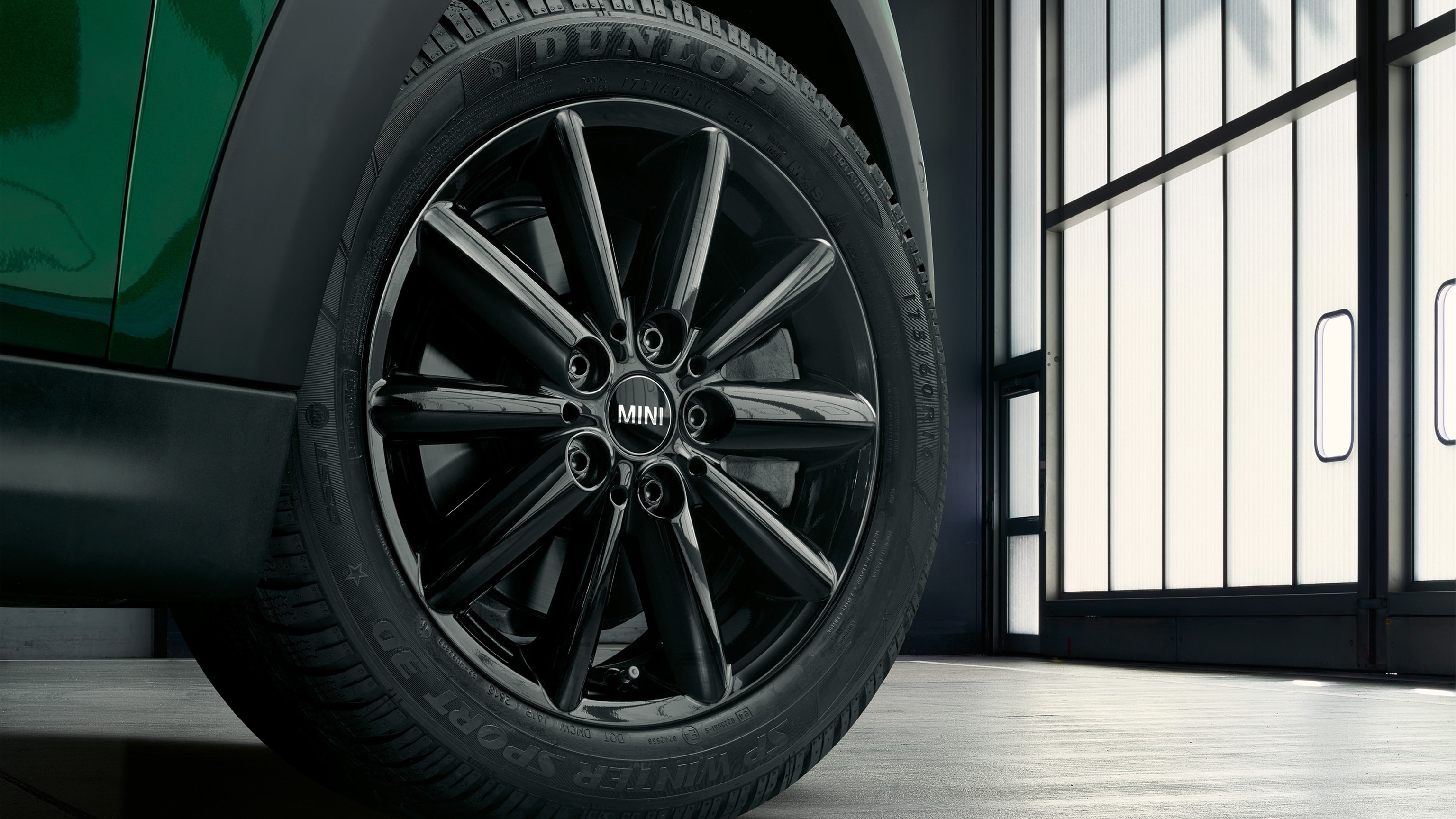 Detail of a MINI tyre in a green car